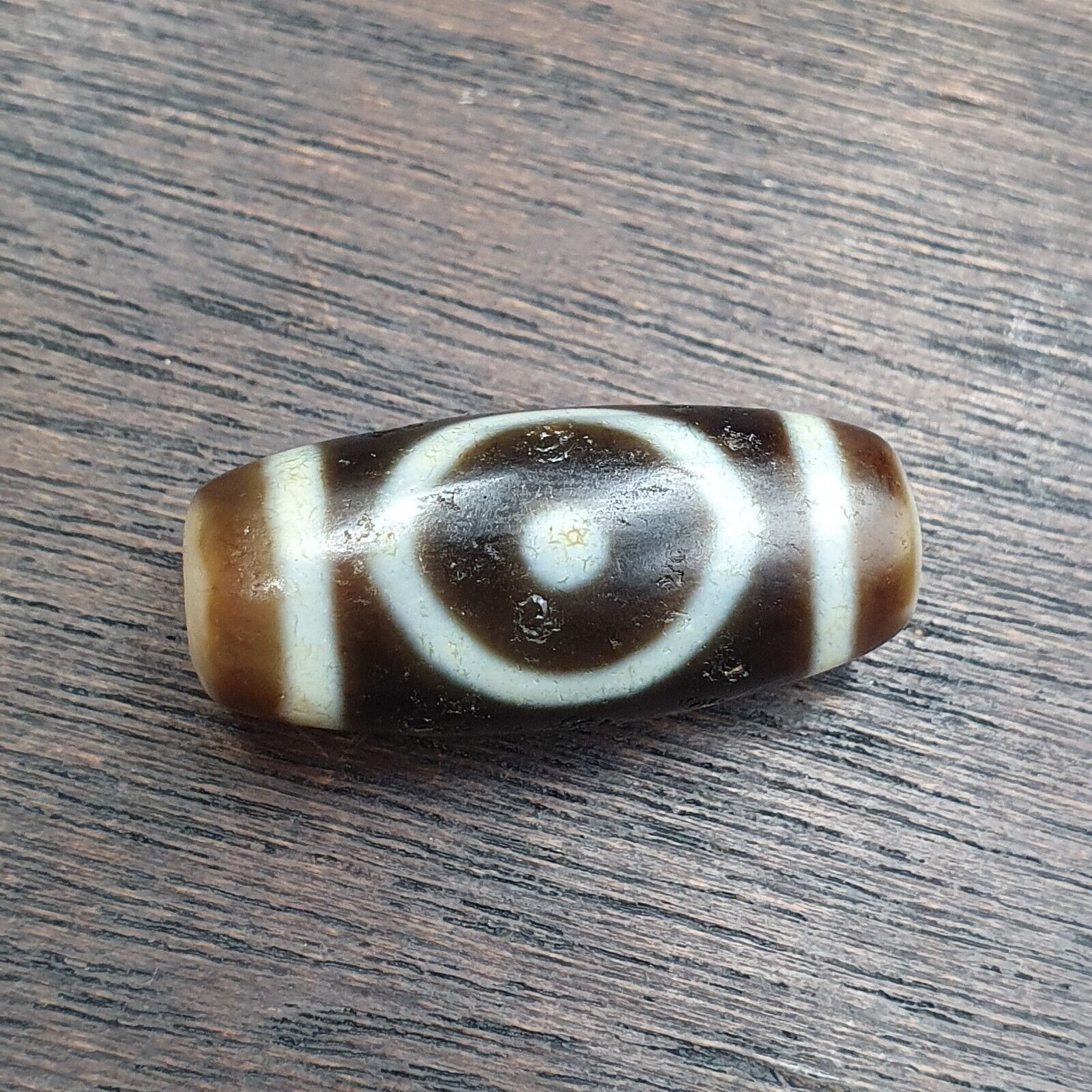 "Two antique Tibetan Agate Dzi beads, featuring a unique 'eyes circle squared' design, symbolizing protection and spiritual growth. These high-quality beads, designated as OTB8-4, are highly valued for their cultural significance, rarity, and believed to bring good fortune, prosperity, and blessings to the wearer as an amulet."