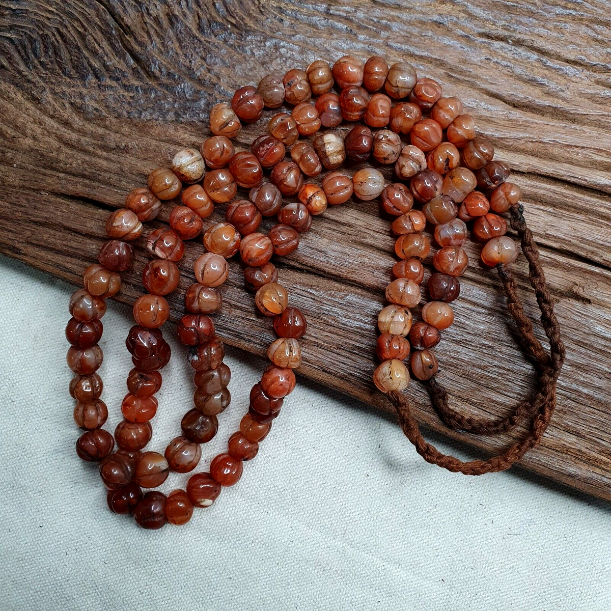 "Two vintage Himalayan Tibetan necklaces featuring melon-shaped carnelian agate beads, showcasing traditional craftsmanship and earthy elegance. Perfect for layering or gifting, these unique pieces of jewelry offer a glimpse into Tibetan culture and history."