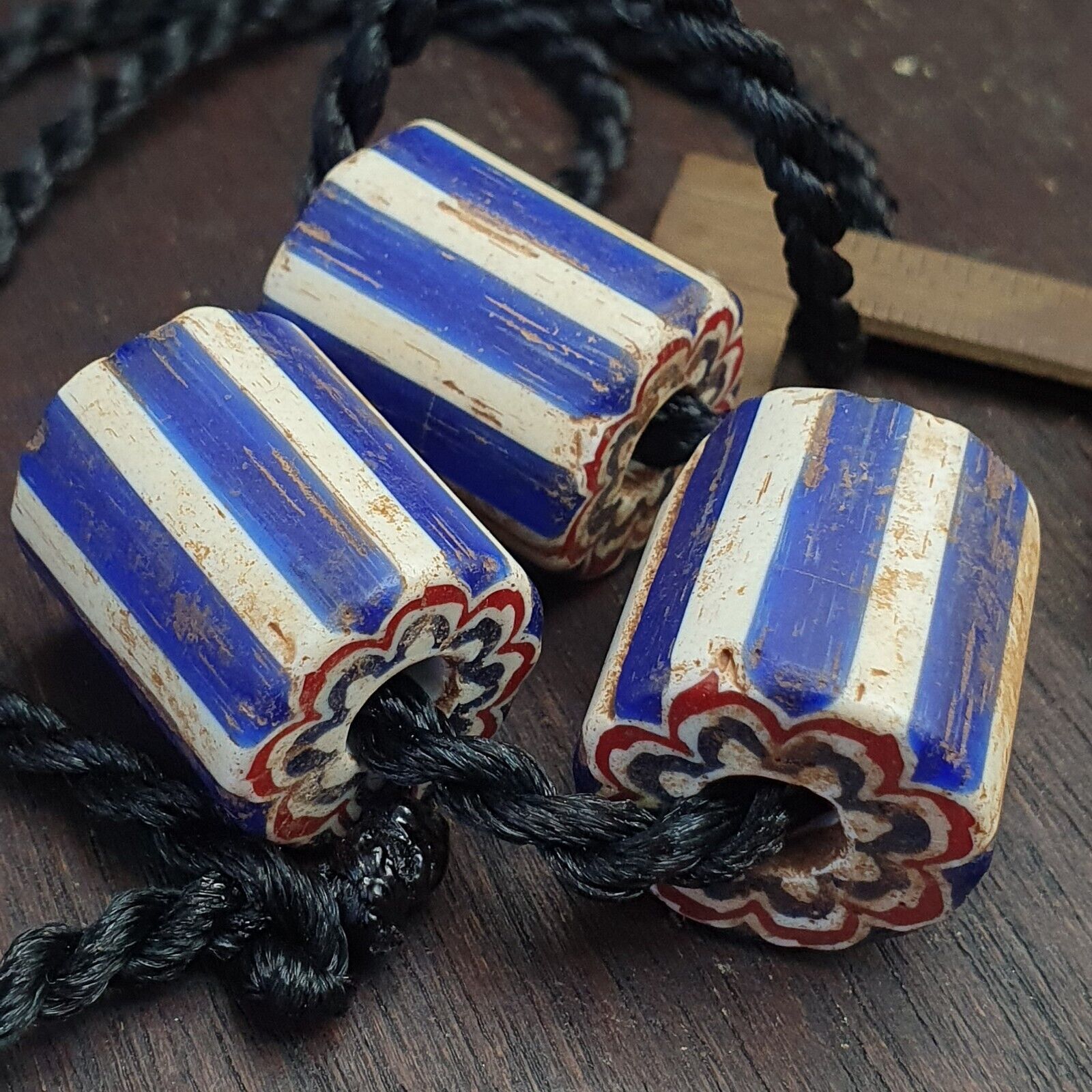 "Image of 3 antique Venetian trade beads, African blue glass chevron beads with large holes, showcasing a rare and vintage find, perfect for jewelry making, collectors, and enthusiasts of African and Venetian cultural heritage."