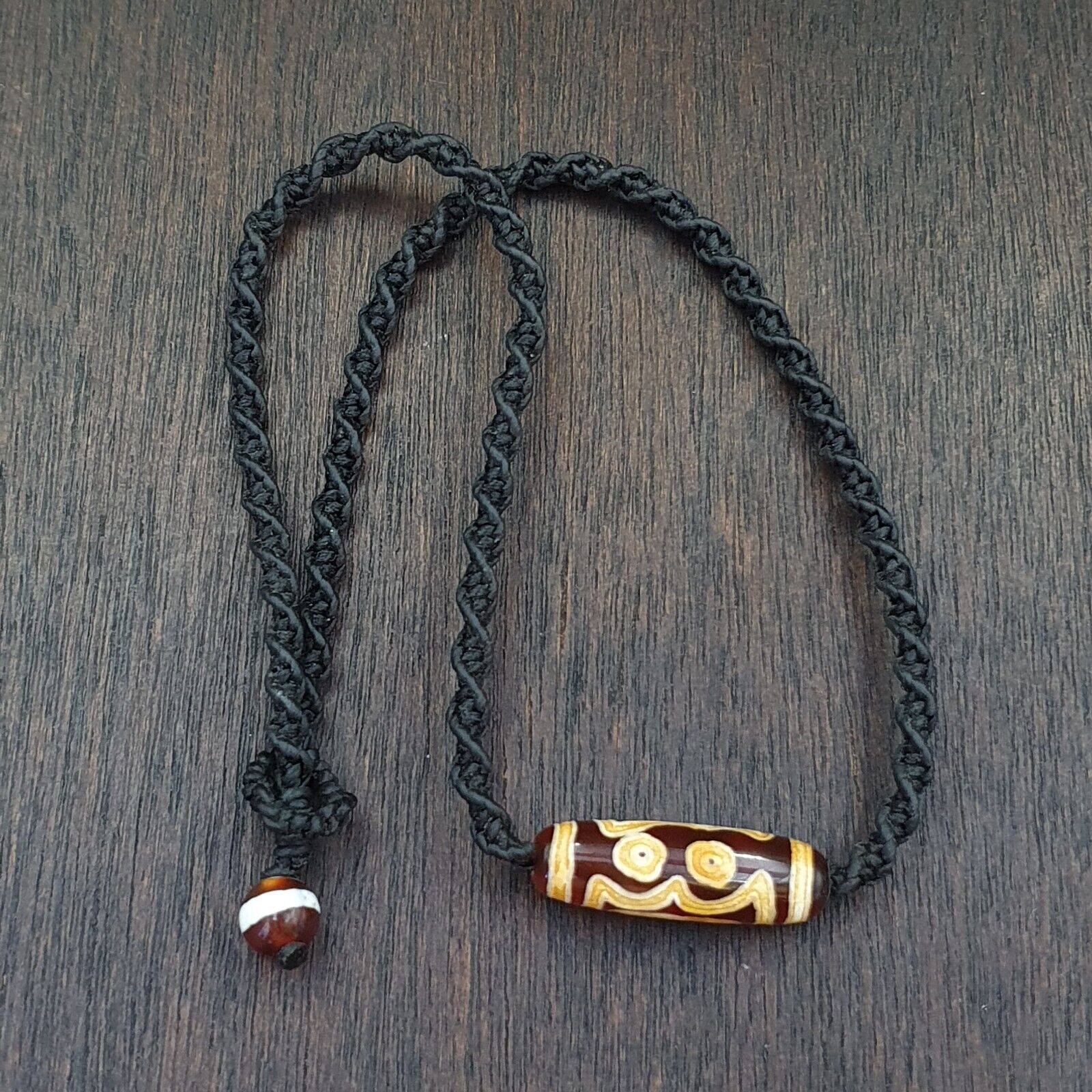 "Image of a vintage Taiwanese red agate pendant necklace featuring an etched 3-eyed bead, an ancient amulet believed to possess spiritual powers, showcasing a rare and precious cultural artifact from a bygone era."