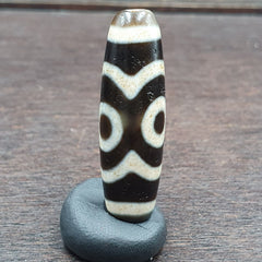 "Image of 3 vintage Himalayan Indo-Tibetan agate beads with a unique 3-eyed pattern, believed to bring spiritual protection and good fortune, showcasing a rare and culturally significant artifact from the Himalayan region."